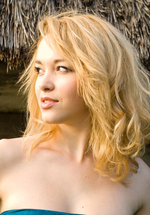 18 year old female Doris G slips off her underwear to pose naked on her bed